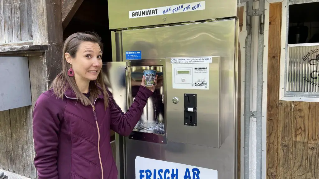 jana drinks milk from a farm vending machine milk vending machine in lauterbrunnen switzerland aplins in the alps