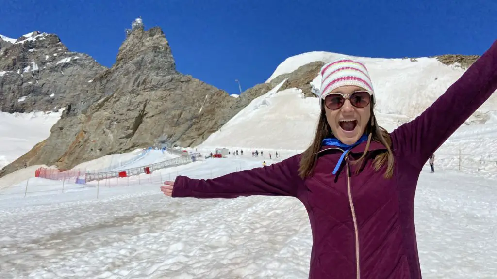 Girl standing on Aletsch Glacier with Jungfraujoch Top of Europe in the background Aplins in the Alps