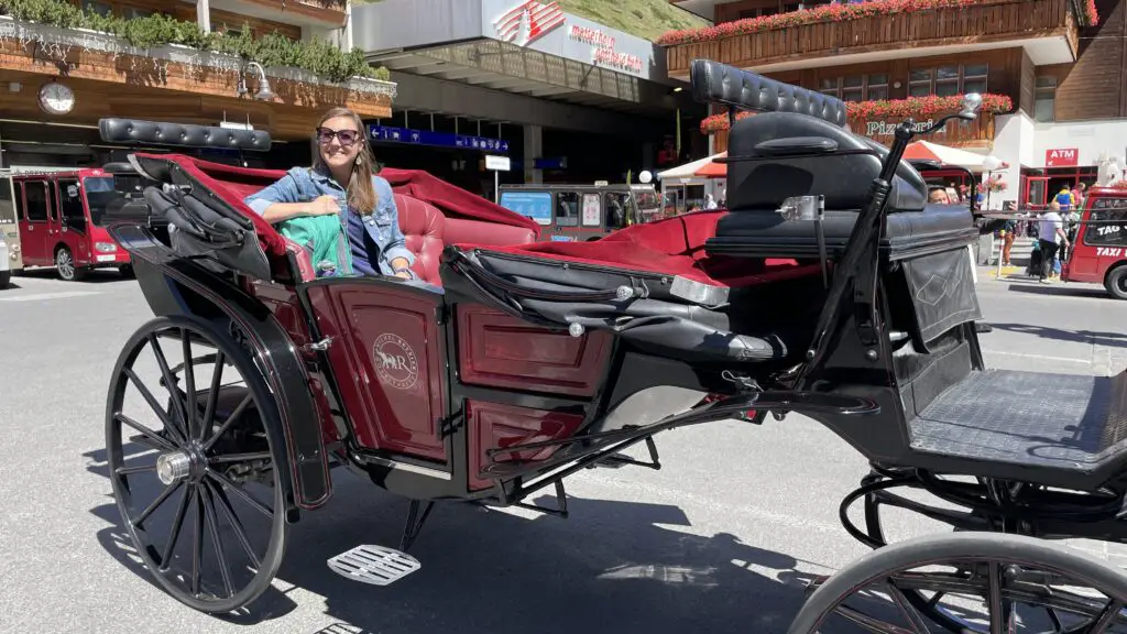 Jana riding a horse drawn carriage in car free zermatt switzerland
