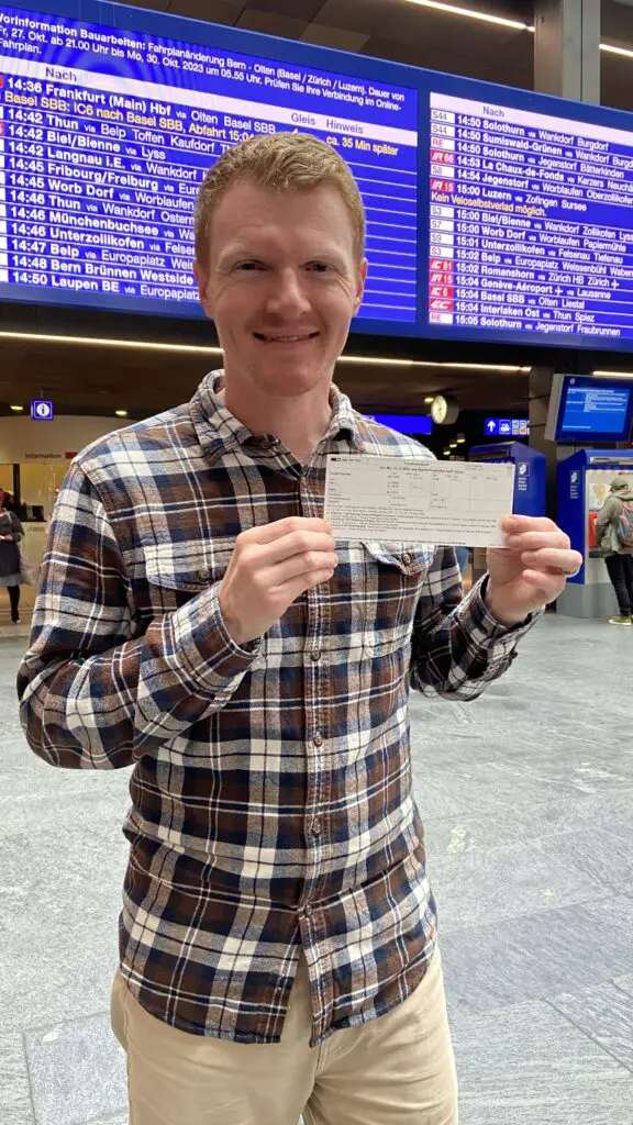 brett holding a swiss train ticket in bern switzerland