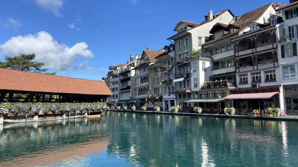 aare river and covered wooden bridge in thun switzerland