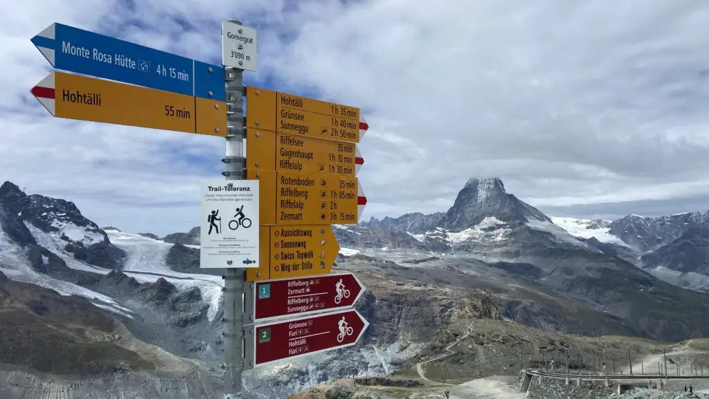 hiking signs at gorngergrat zermatt in front of the matterhorn mountain