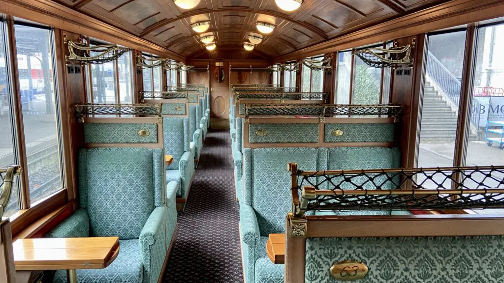 first class goldenpass express belle epoch carriage with plush seats and wooden ceiling