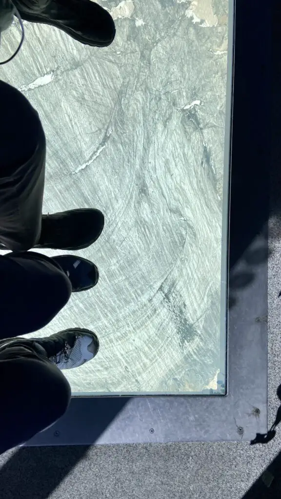 looking at through the glass floor to the glaciers below on the crystal ride to matterhorn glacier paradise