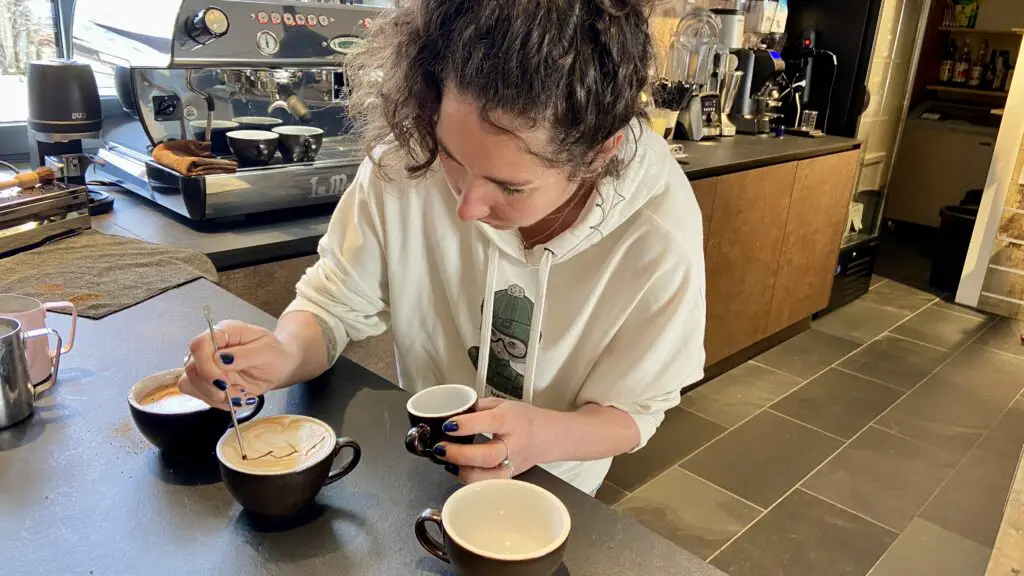 belinda drawing the famous eiger monch and jungfrau mountains on a mountain cappuccino insport coffee bar murren
