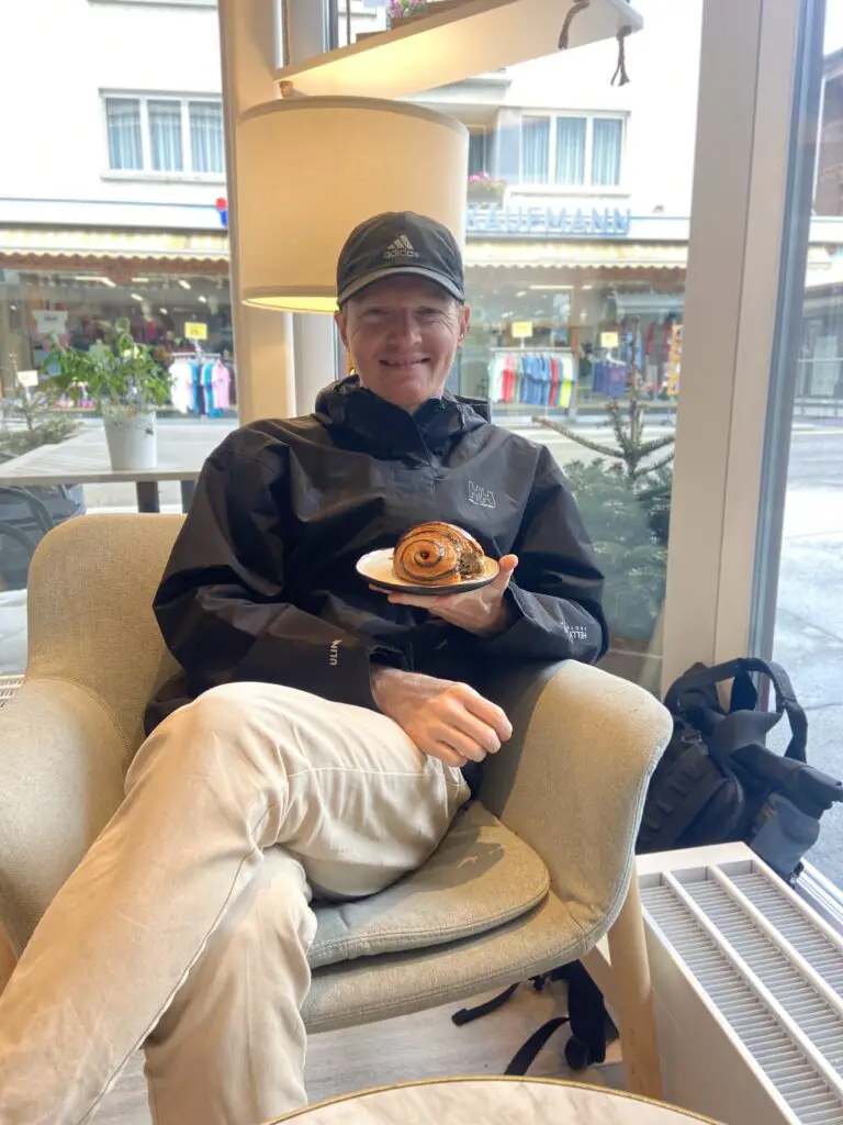 brett eating a chocolate croissant at qraftwerk bakery grindelwald switzerland