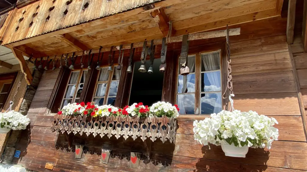 cow bells and flower boxes on Brunngasse brienz switzerland most beautiful street in the world