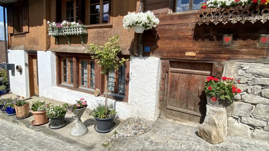 flower boxes, windows, and wooden doors on the most beautiful street in the world brunngasse brienz switzerland