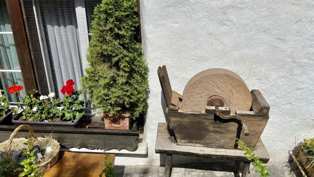 old mill wheel and flower pots on the second most beautiful street in the world brunngasse switzerland brienz