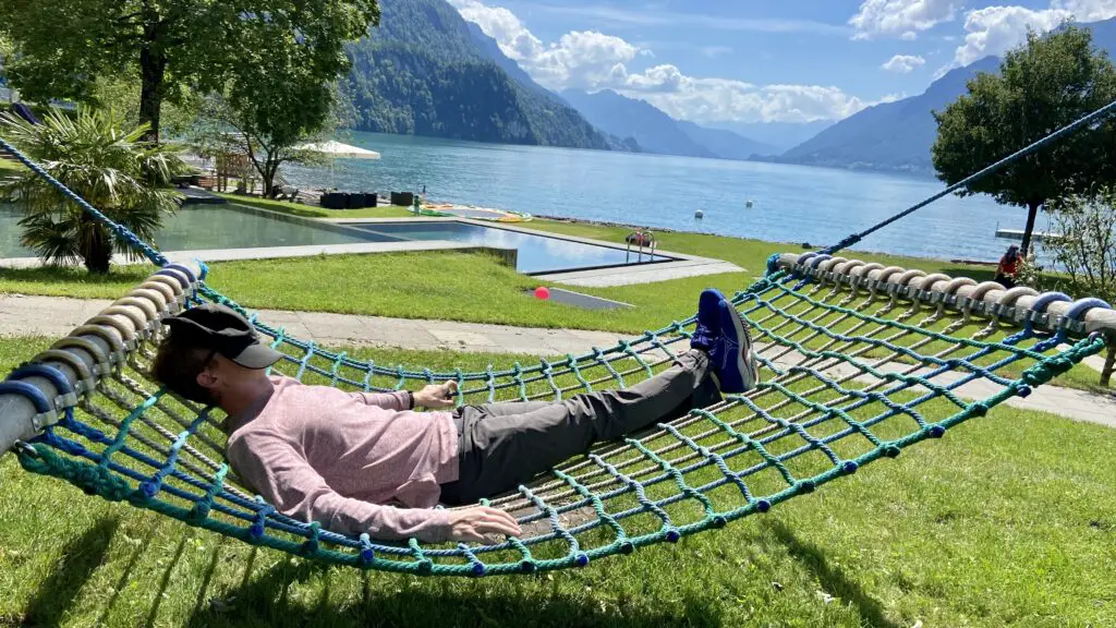 brett laying in a hammock at strandbad brienz