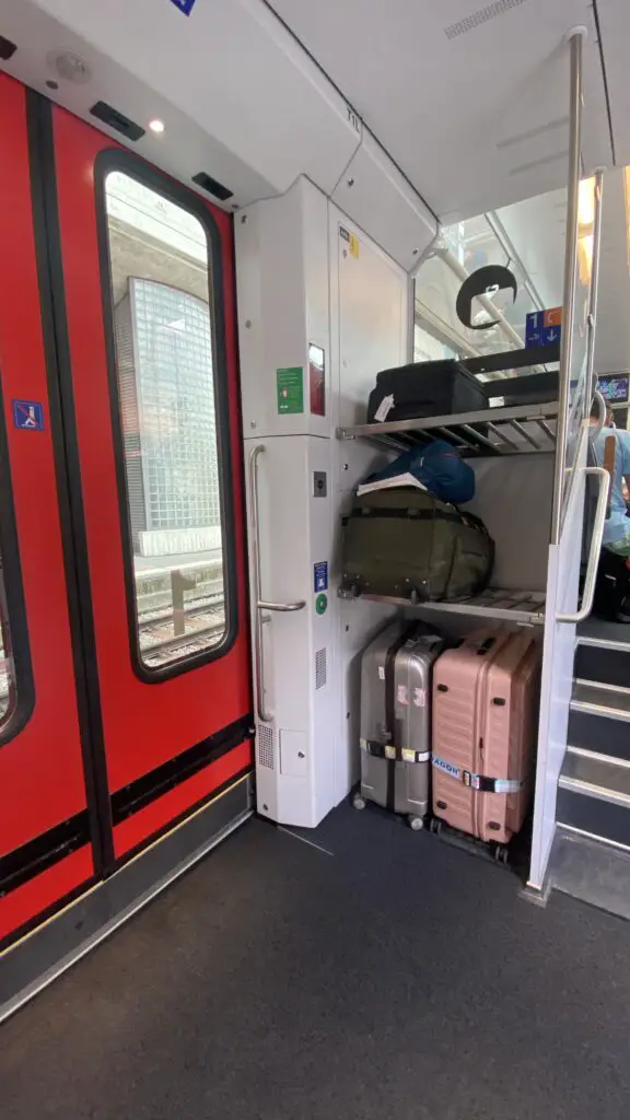 luggage racks by the doors of the luzern interlaken express