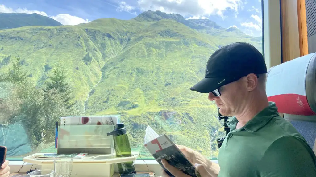 brett reading the glacier express brochure