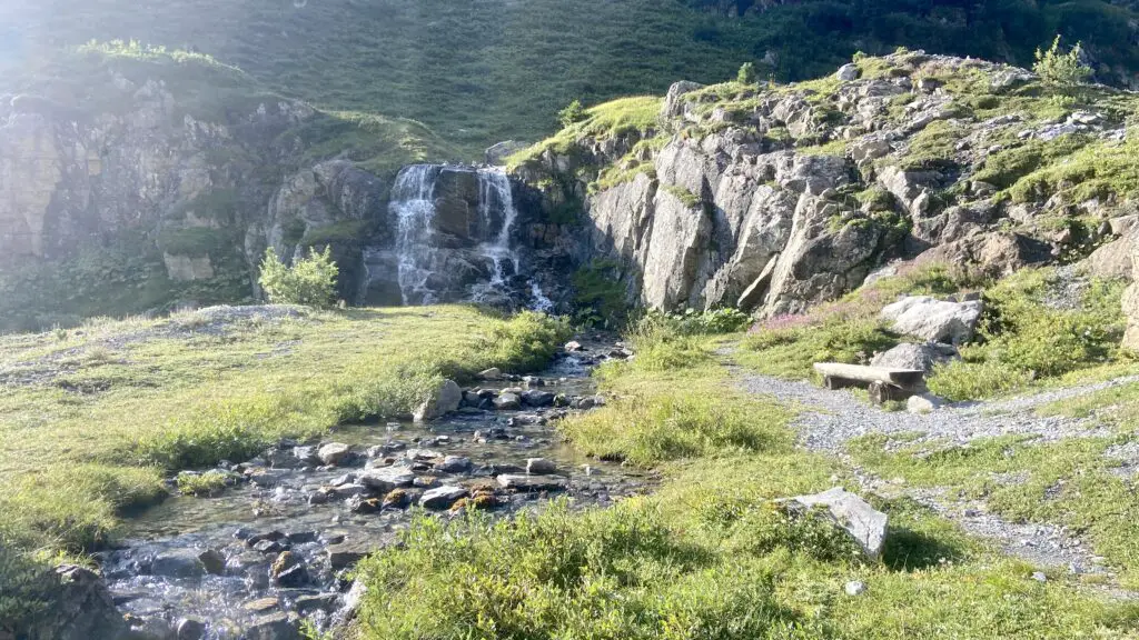 meadow and waterfall on the trail to oberhornsee switzerland