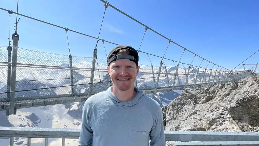 brett from aplins in the alps in front of the titlis suspension bridge the highest suspension bridge in europe
