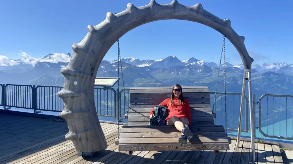 jana from aplins in the alps sitting on the ibex swing at brienzer rothorn