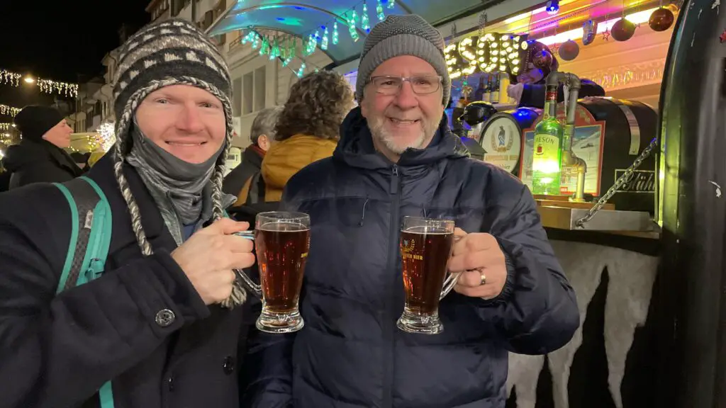 brett aplin drinking appenzeller glühbier at swiss christmas market in basel switzerland