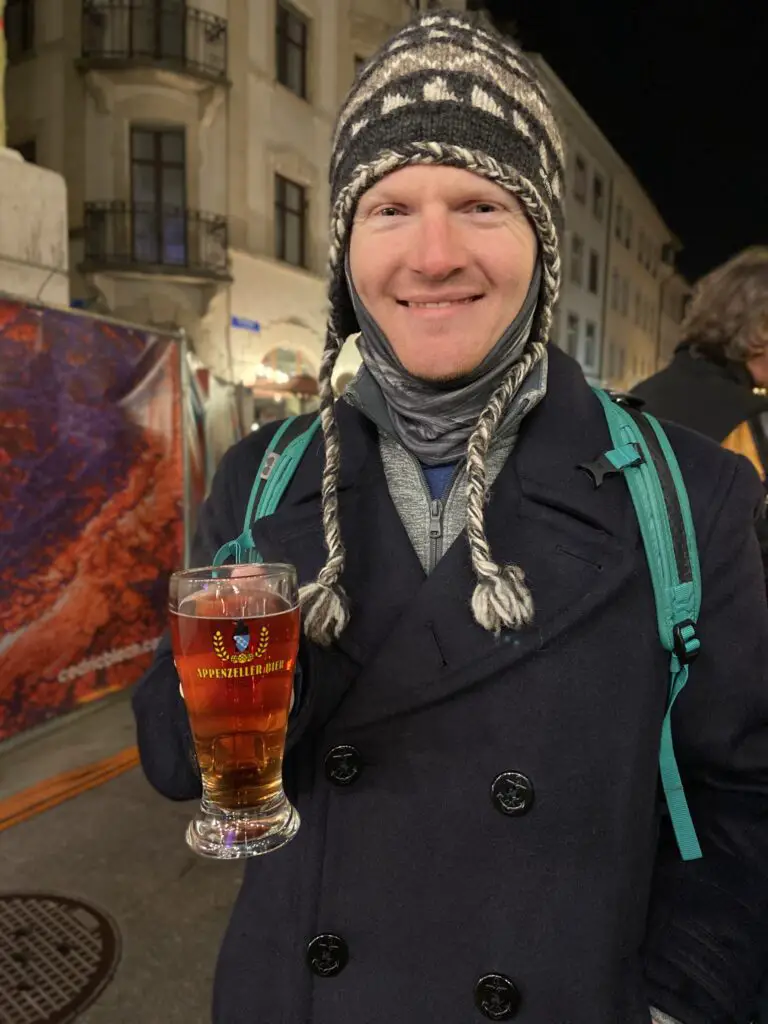 brett aplin from aplins in the alps drinking appenzeller glühbier at swiss christmas market