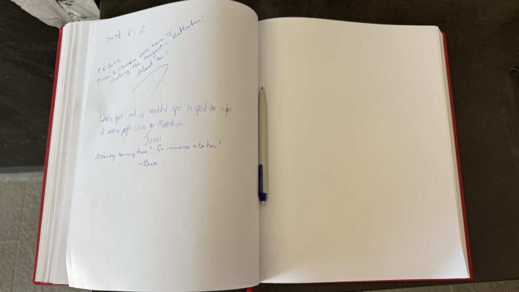 signing the guestbook at the hornli hut at the base of the matterhorn