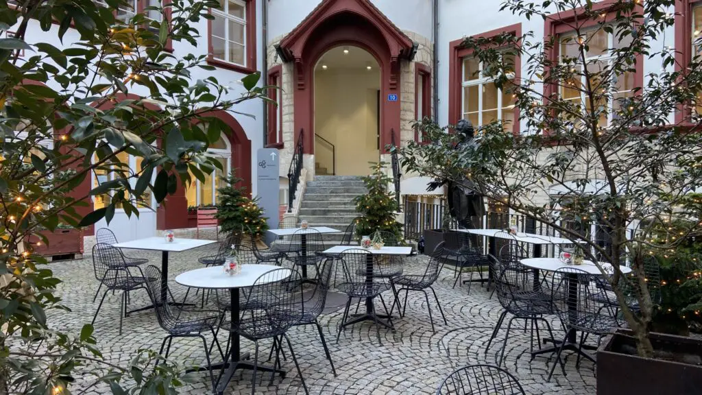 basel switzerland magical courtyards outdoor seating with christmas trees and lights