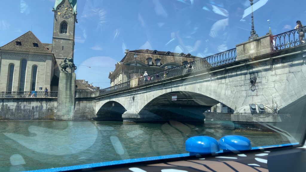 limmat river boat going under bridge