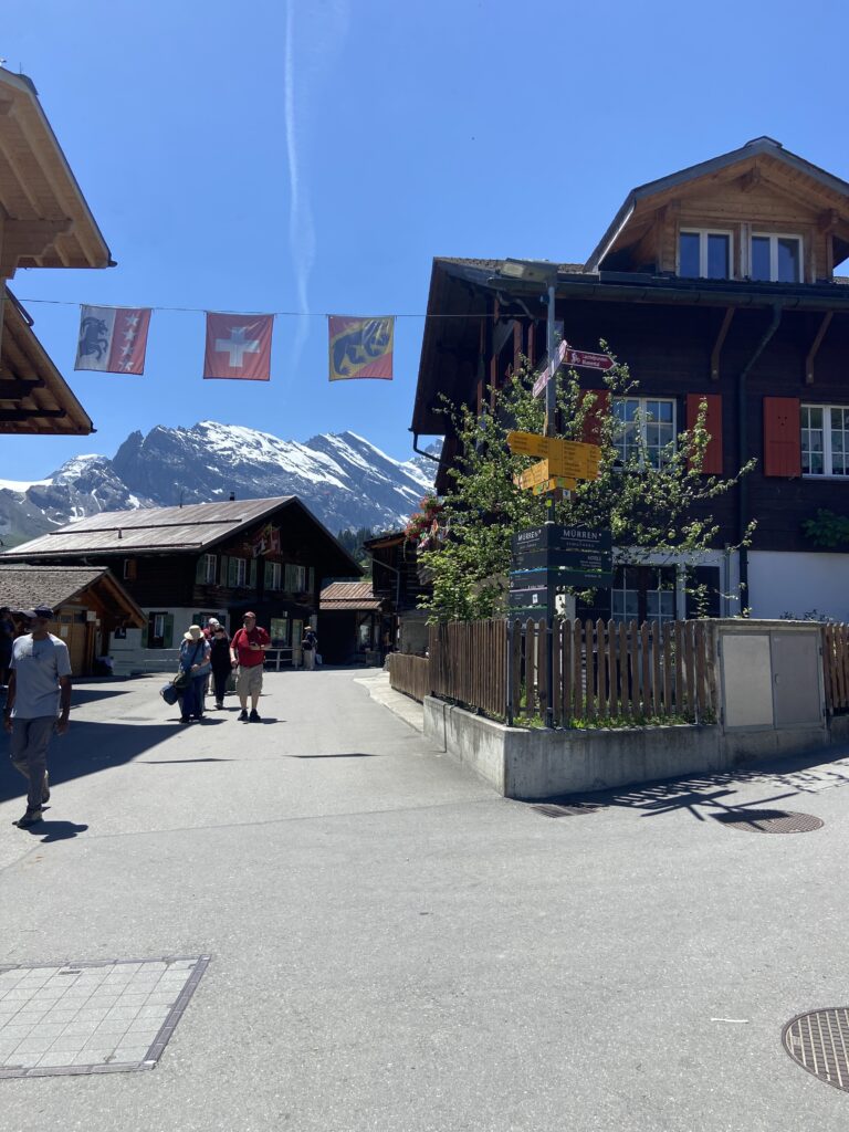murren switzerland street with flags and trail signs